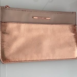 Rose gold leather wristlet clutch